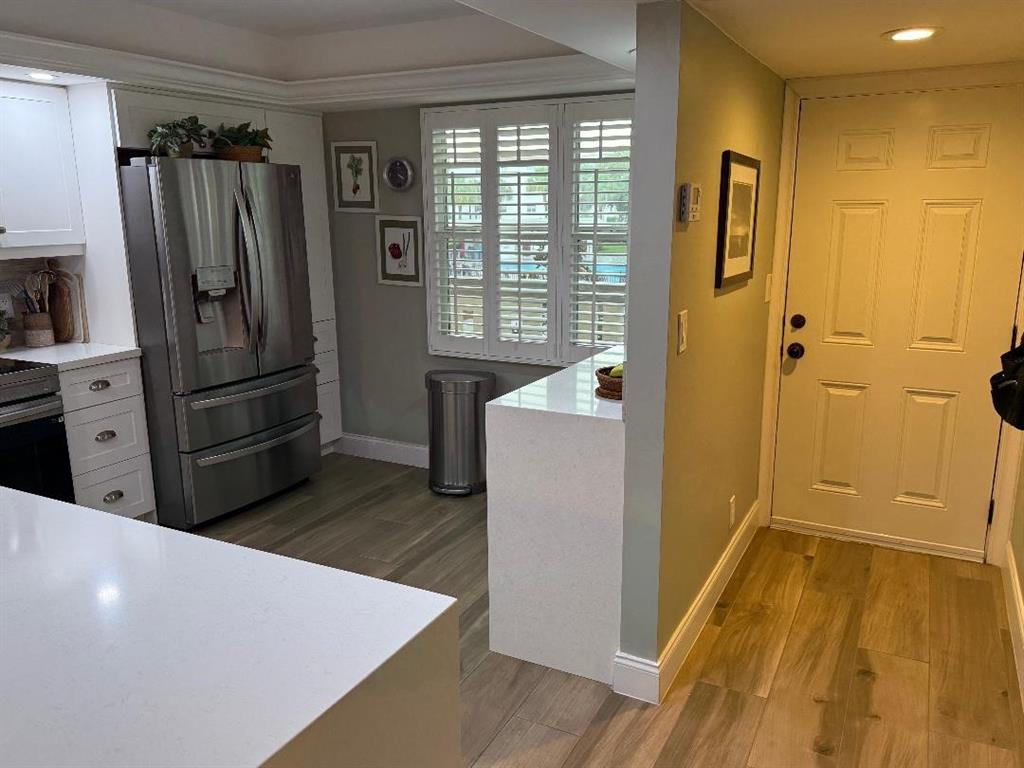 3403 Bimini Lane, Unit G2 Coconut Creek, FL 33066 - Photo 4 of 12 a kitchen with a refrigerator and a sink
