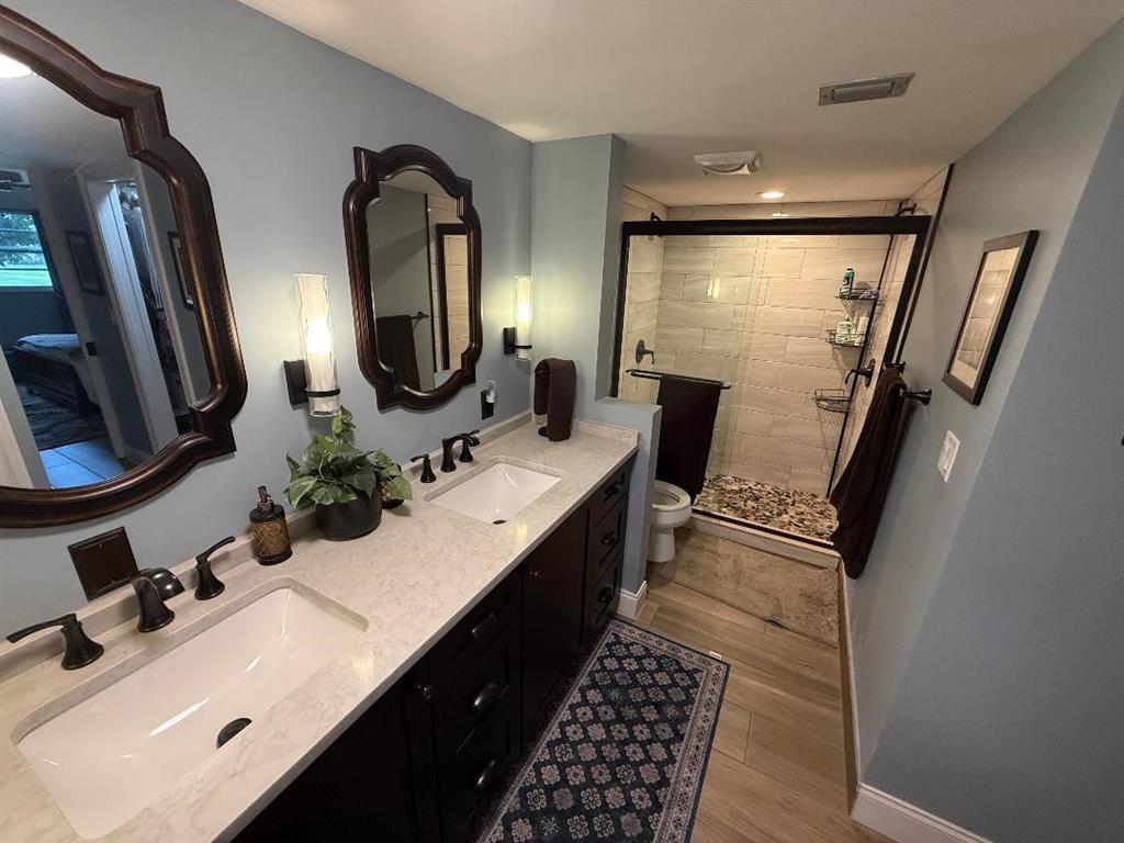 3403 Bimini Lane, Unit G2 Coconut Creek, FL 33066 - Photo 7 of 12 a bathroom with double vanity and a mirror