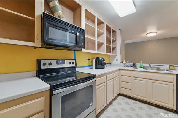 a kitchen with stainless steel appliances a stove and a microwave