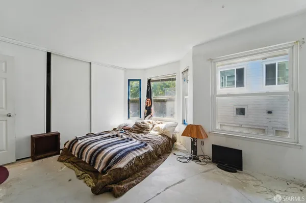 a bedroom with a bed and window