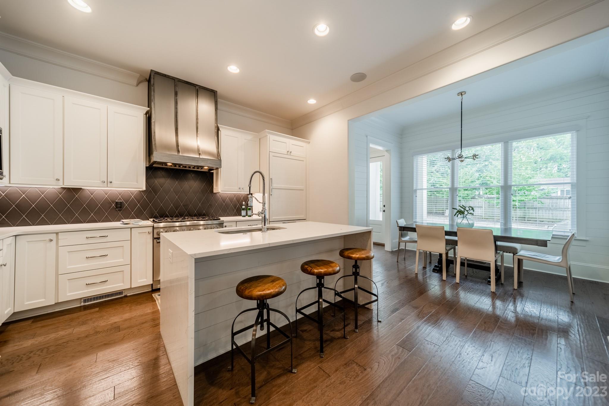 744 Ellsworth Road Charlotte, NC 28211 - Photo 20 of 31 a kitchen with sink cabinets and wooden floor