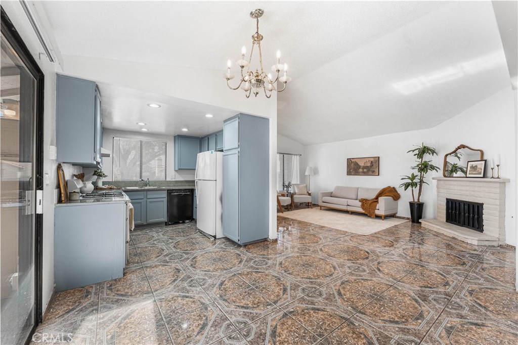 3542 East Ave R 10 Palmdale, CA 93550 - Photo 13 of 35 a view of a kitchen with furniture and a fireplace