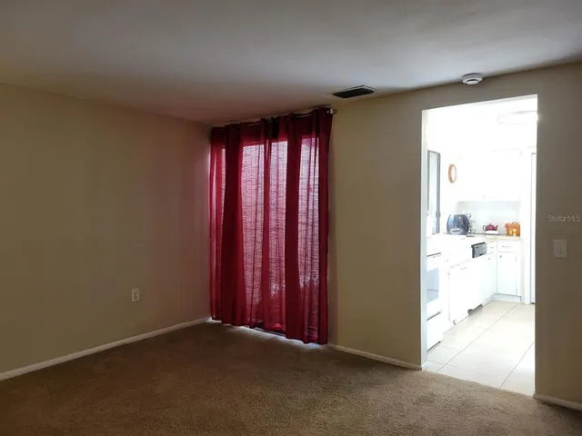 a bed sitting in a room next to a window