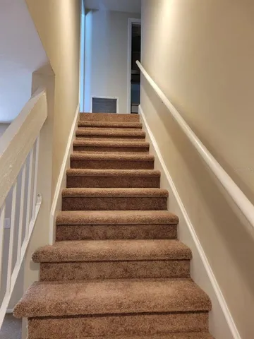 a wooden floor with a table and chair in it