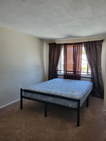 an empty room with windows and closet