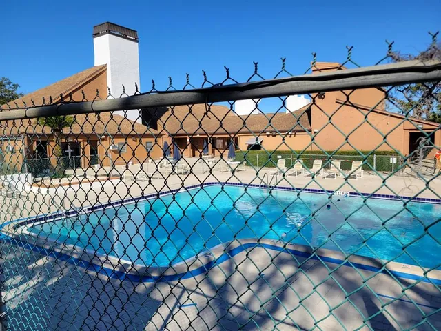 a view of a backyard with wooden fence