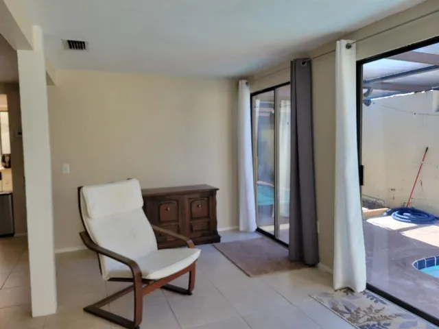 a view of a workspace with furniture and a window