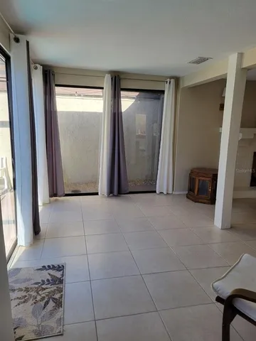 a view of an empty room and a window