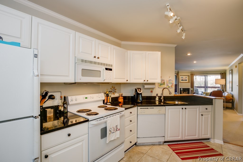 63 Mariners Point Lane, Unit A Hartfield, VA 23071 - Photo 11 of 29 The kitchen has tile floors, crown molding, updated lighting and modern fixtures.