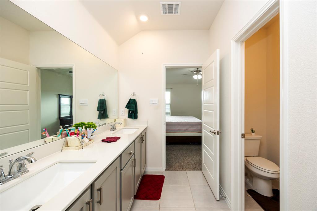 3229 Trails End Road Aubrey, TX 76227 - Photo 14 of 25 Bathroom featuring ensuite bath, double vanity, plenty of natural light, and light tile patterned flooring