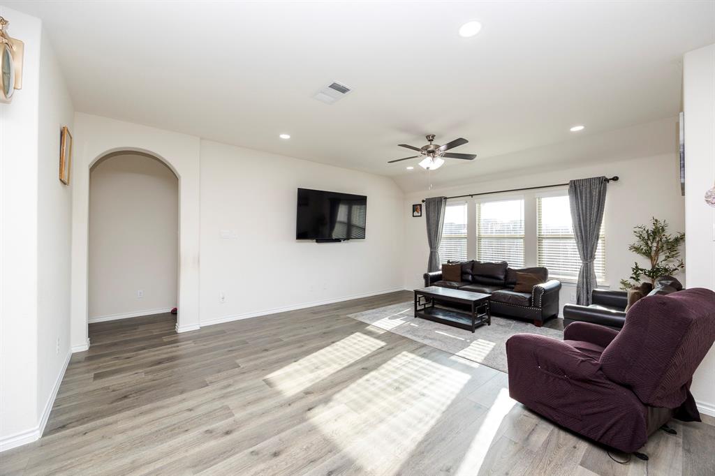 3229 Trails End Road Aubrey, TX 76227 - Photo 16 of 25 Living room featuring arched walkways, recessed lighting, light wood finished floors, and ceiling fan