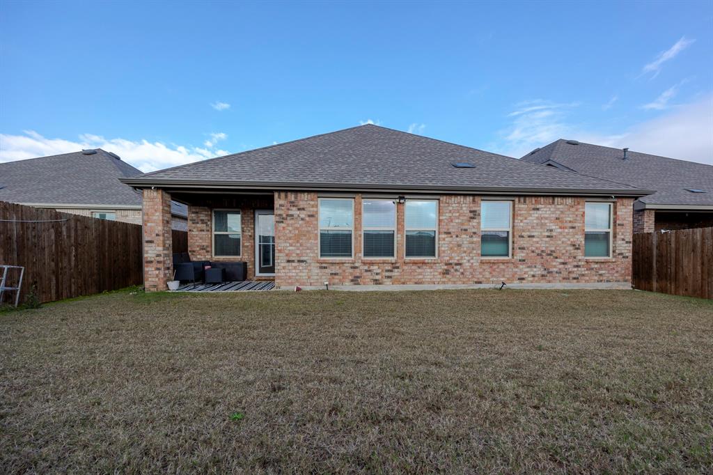 3229 Trails End Road Aubrey, TX 76227 - Photo 22 of 25 Rear view of property with a fenced backyard, a shingled roof, a patio area, and brick siding