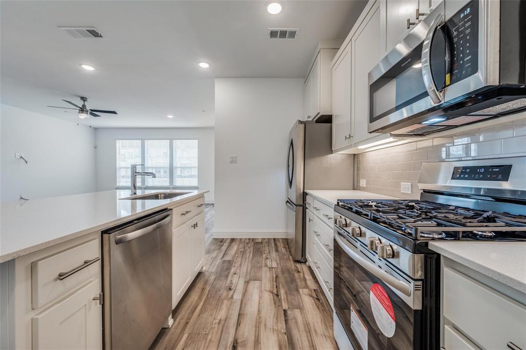 8940 Samara Street Frisco, TX 75035 - Photo 2 of 28 a kitchen with granite countertop a stove and a sink
