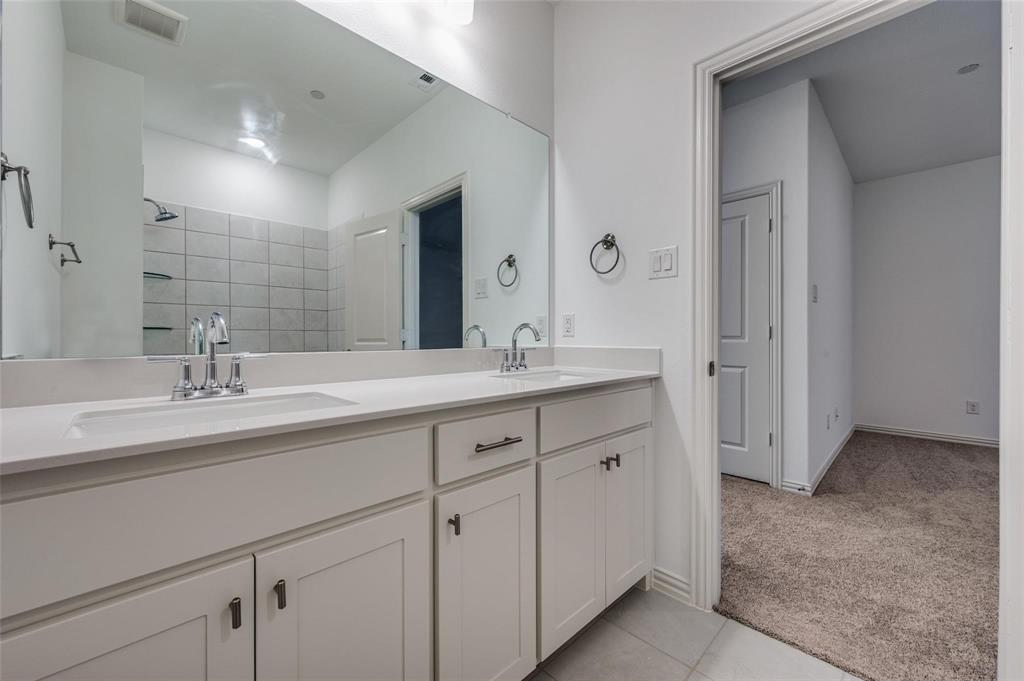 8940 Samara Street Frisco, TX 75035 - Photo 21 of 28 a bathroom with double sink and a mirror