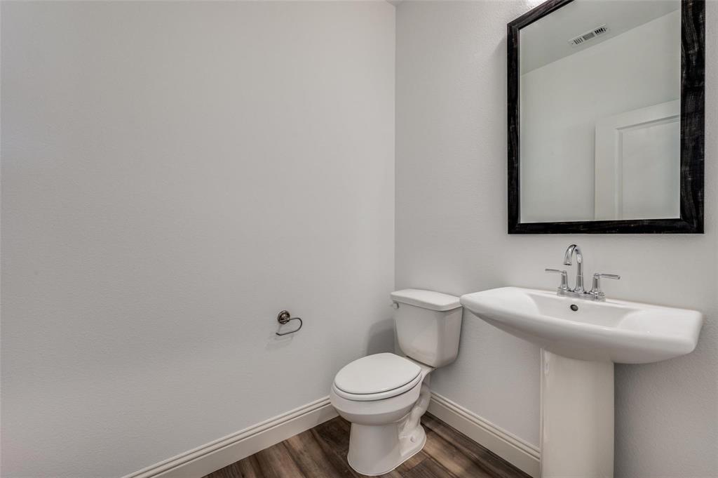 8940 Samara Street Frisco, TX 75035 - Photo 22 of 28 a bathroom with a sink a toilet and mirror