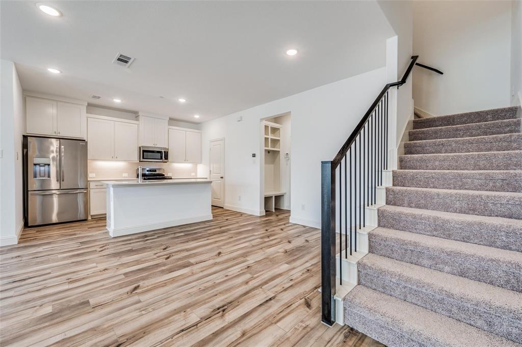8940 Samara Street Frisco, TX 75035 - Photo 3 of 28 a view of kitchen with wooden floor and electronic appliances