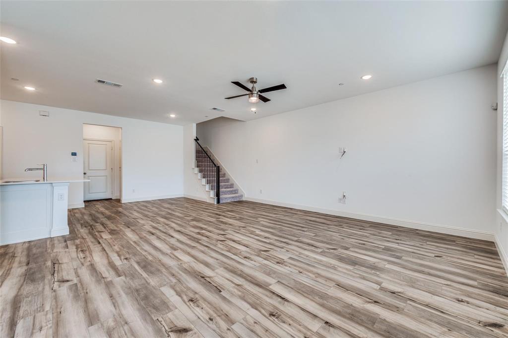 8940 Samara Street Frisco, TX 75035 - Photo 8 of 28 a view of a room with a ceiling fan and hardwood floor