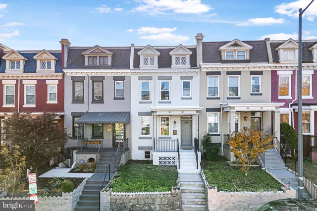 a front view of a residential apartment building with a yard