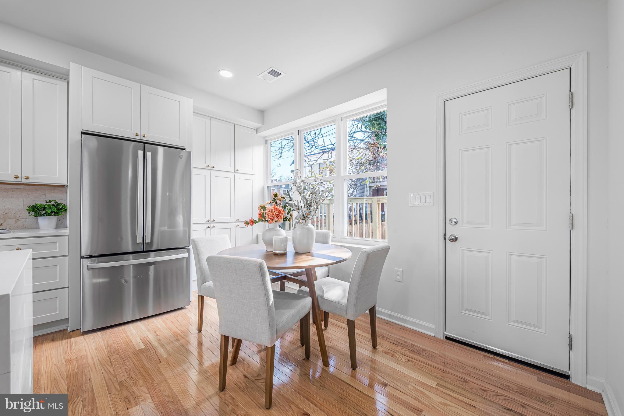 177 V Street Northeast Washington, DC 20002 - Photo 13 of 32 a kitchen with stainless steel appliances a refrigerator a table and chairs