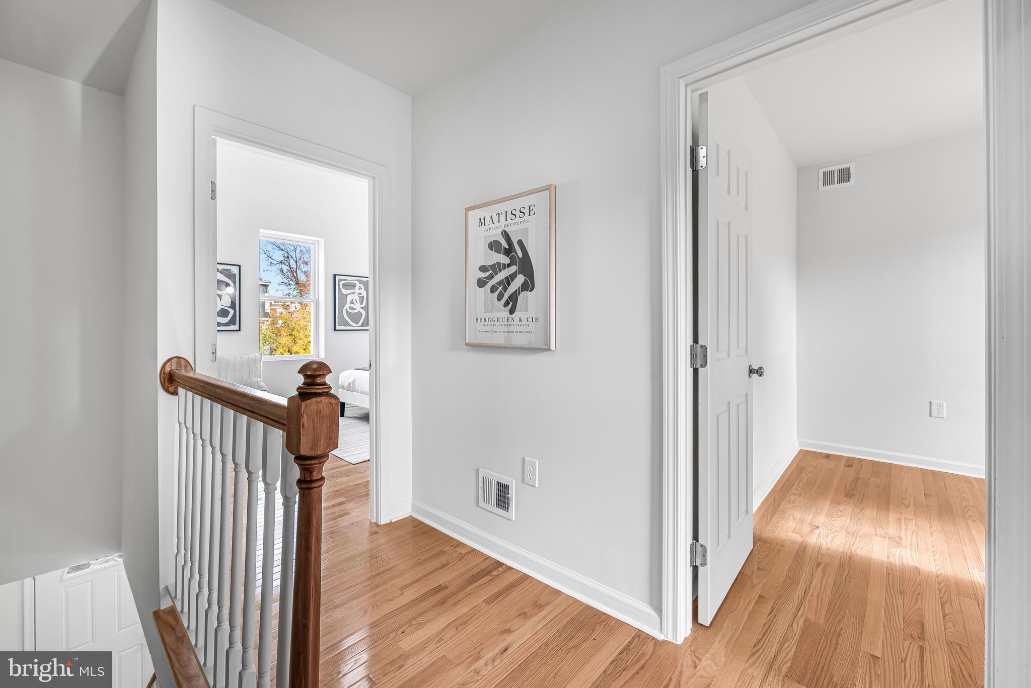 177 V Street Northeast Washington, DC 20002 - Photo 17 of 32 a view of a hallway with wooden floor and a livingroom