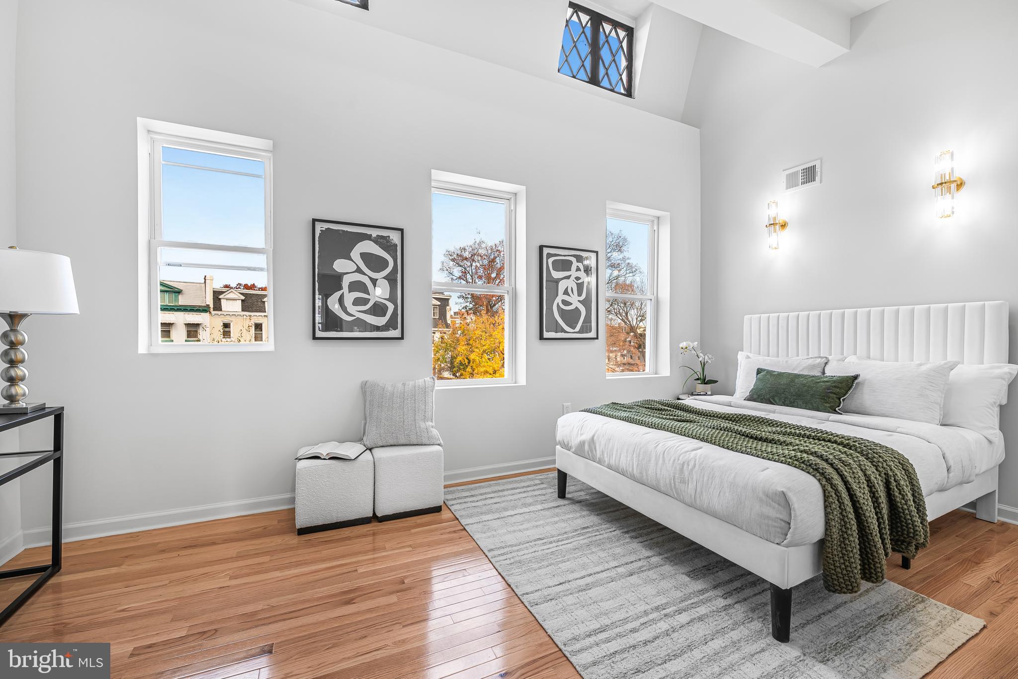177 V Street Northeast Washington, DC 20002 - Photo 18 of 32 a spacious bedroom with a bed and painting on the wall