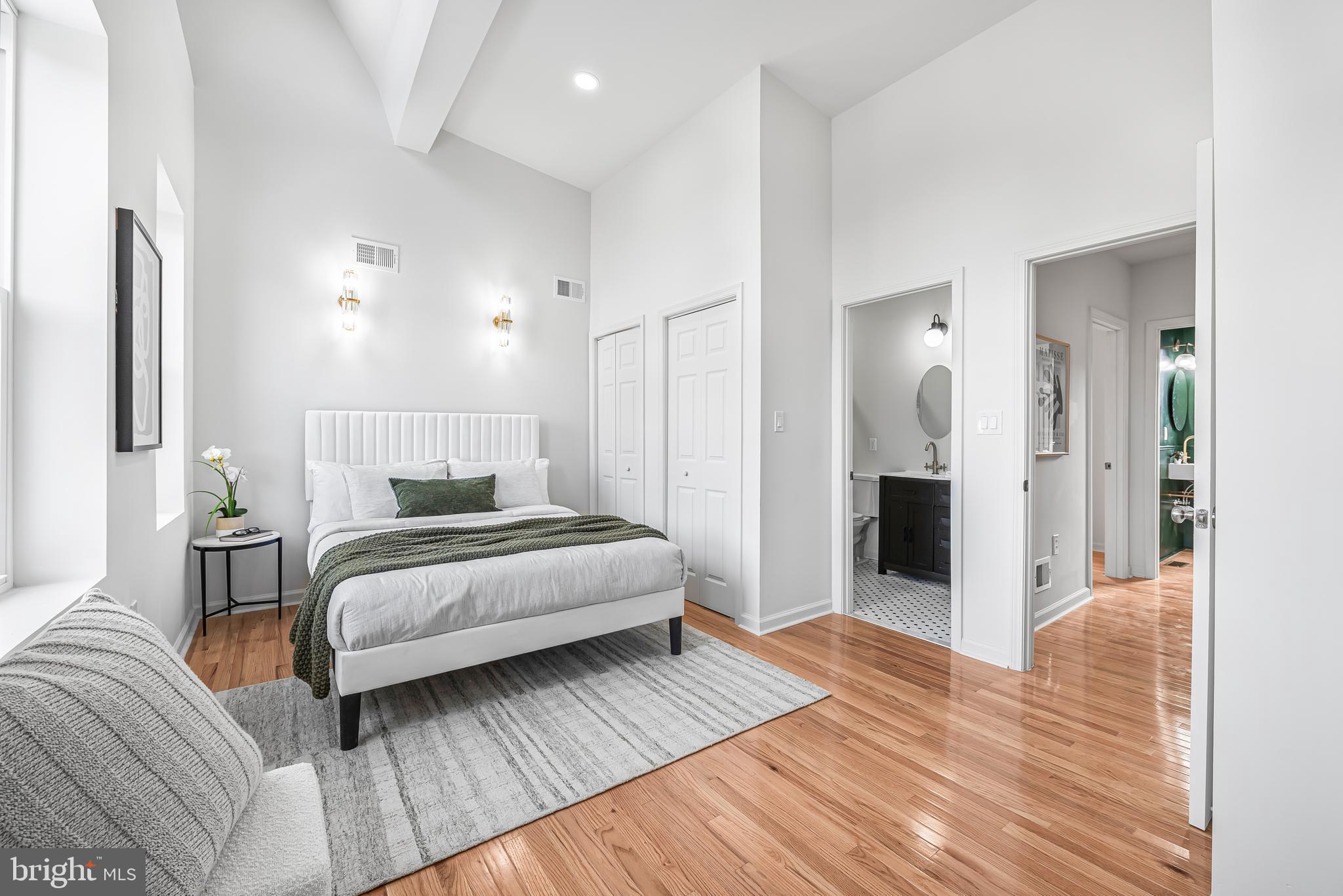 177 V Street Northeast Washington, DC 20002 - Photo 19 of 32 a spacious bedroom with a bed and a table