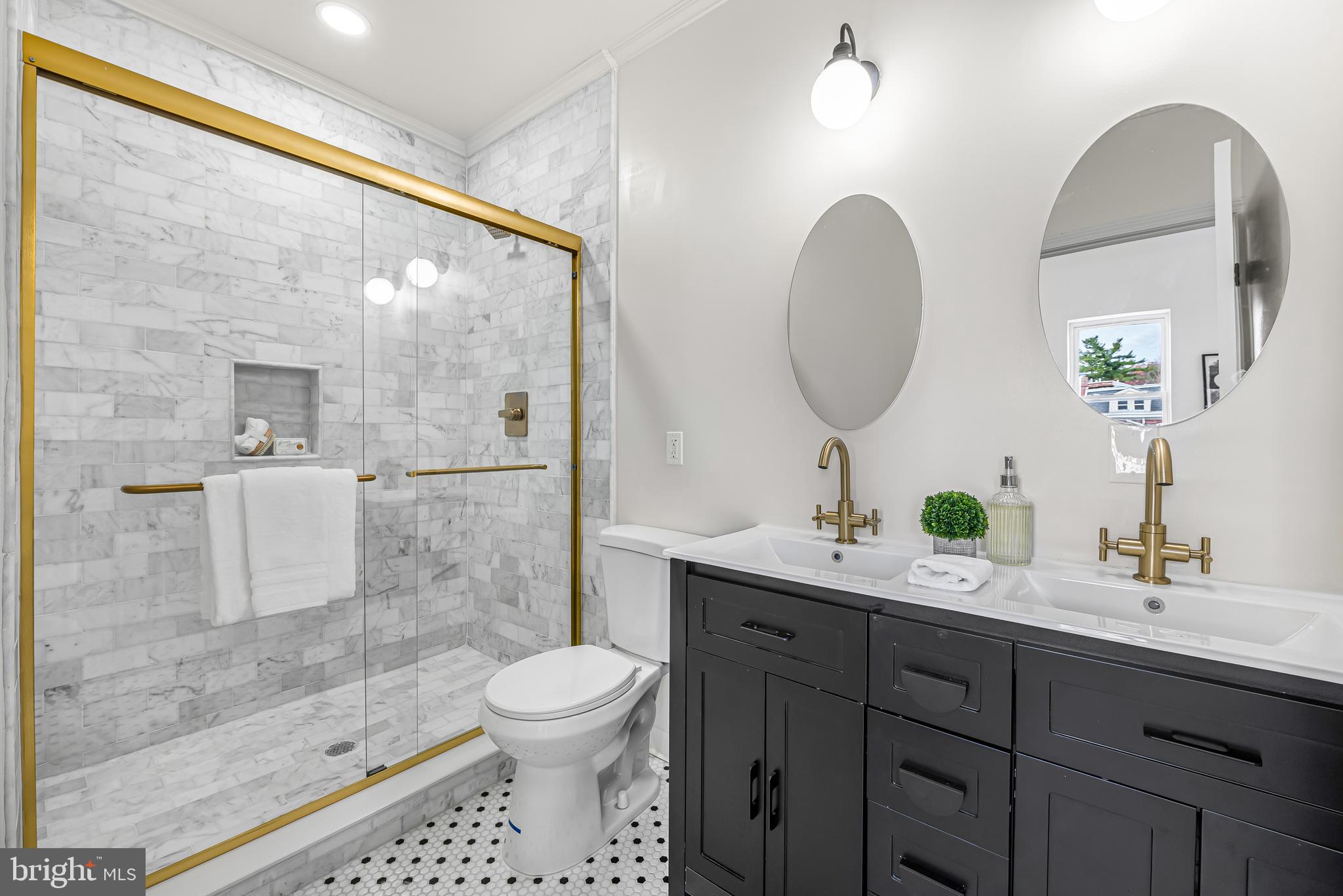 177 V Street Northeast Washington, DC 20002 - Photo 20 of 32 a bathroom with a double vanity sink mirror and toilet