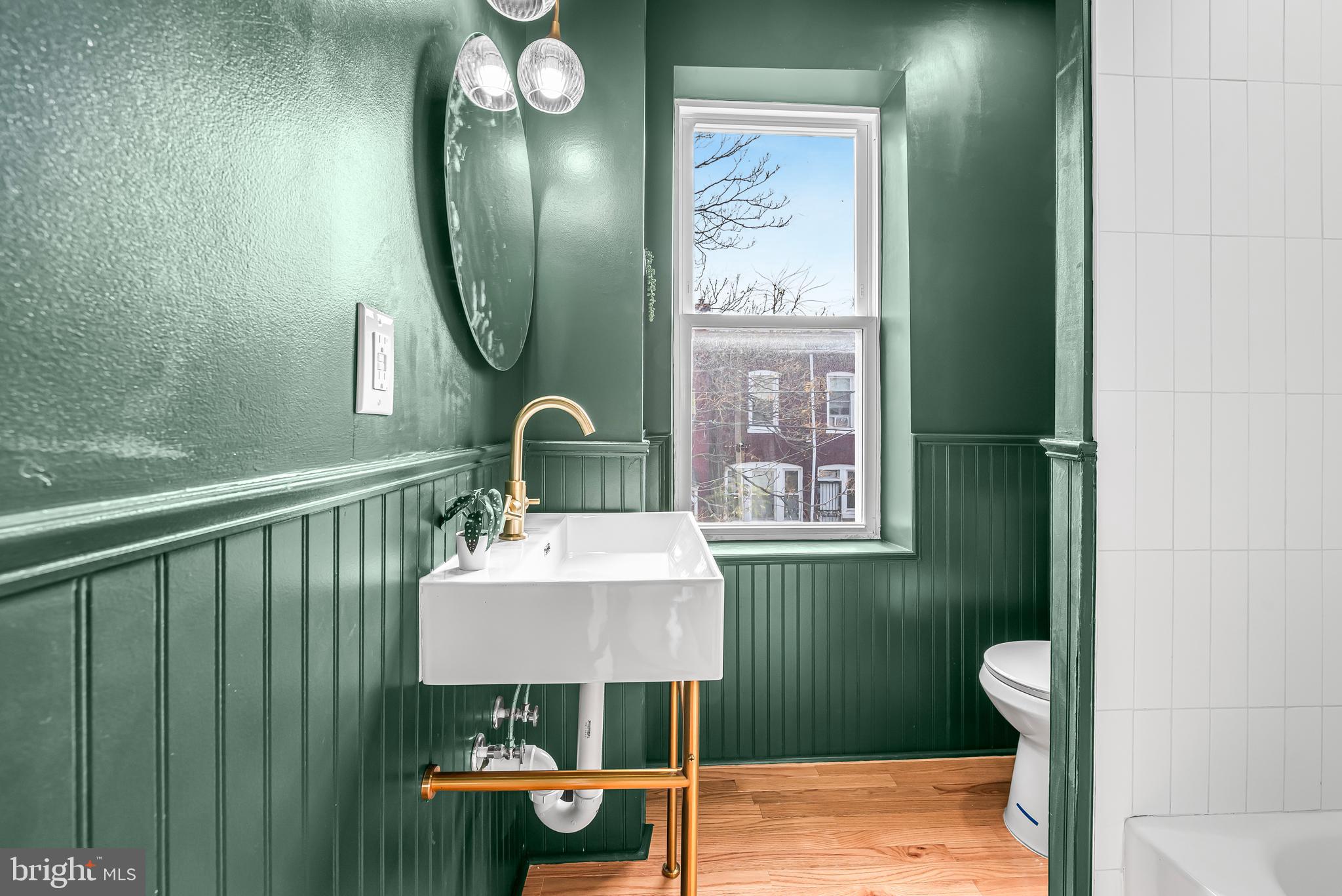 177 V Street Northeast Washington, DC 20002 - Photo 22 of 32 a bathroom with a toilet sink and mirror