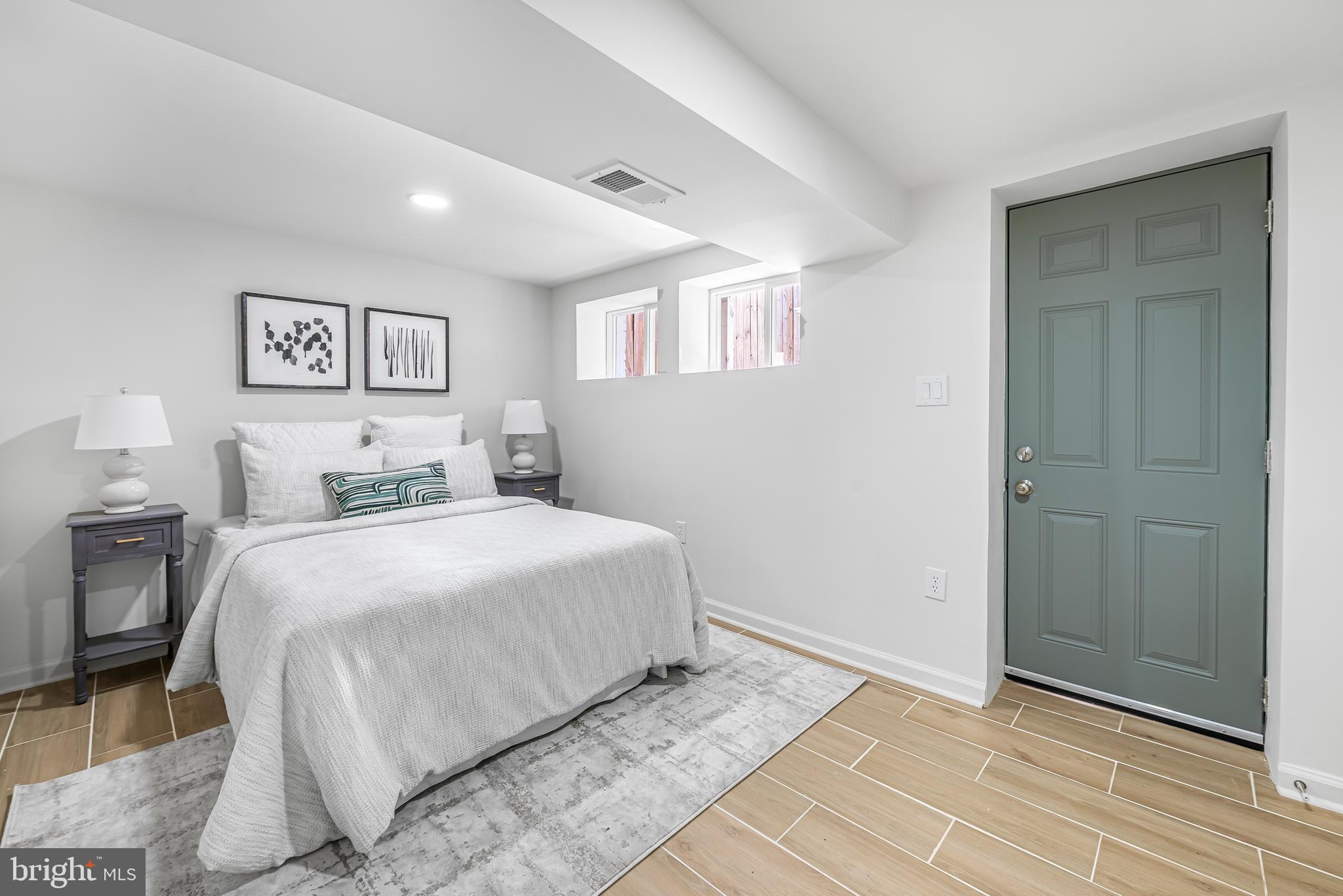 177 V Street Northeast Washington, DC 20002 - Photo 29 of 32 a bedroom with a bed and a painting on the wall