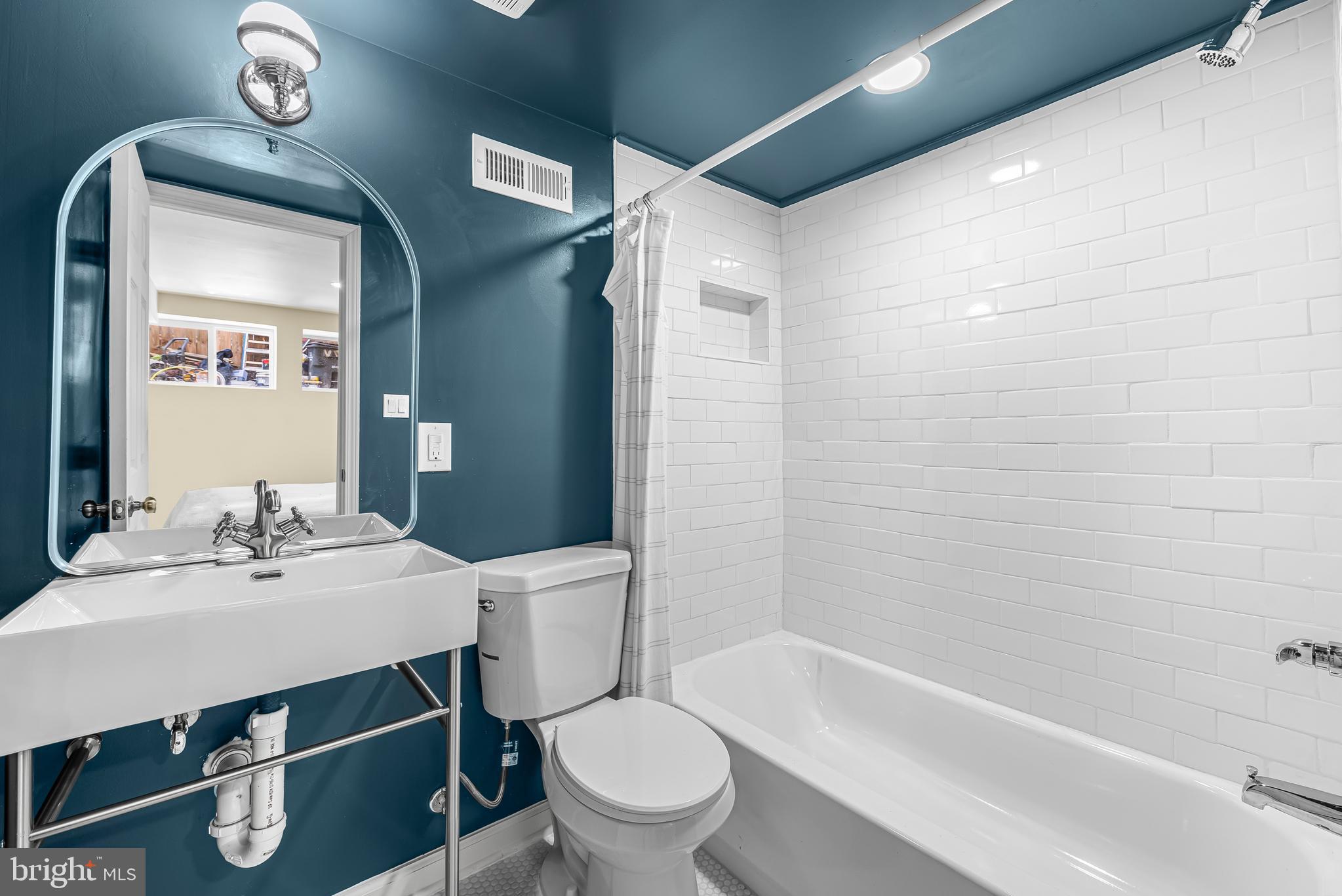 177 V Street Northeast Washington, DC 20002 - Photo 30 of 32 a bathroom with a sink mirror toilet and bathtub