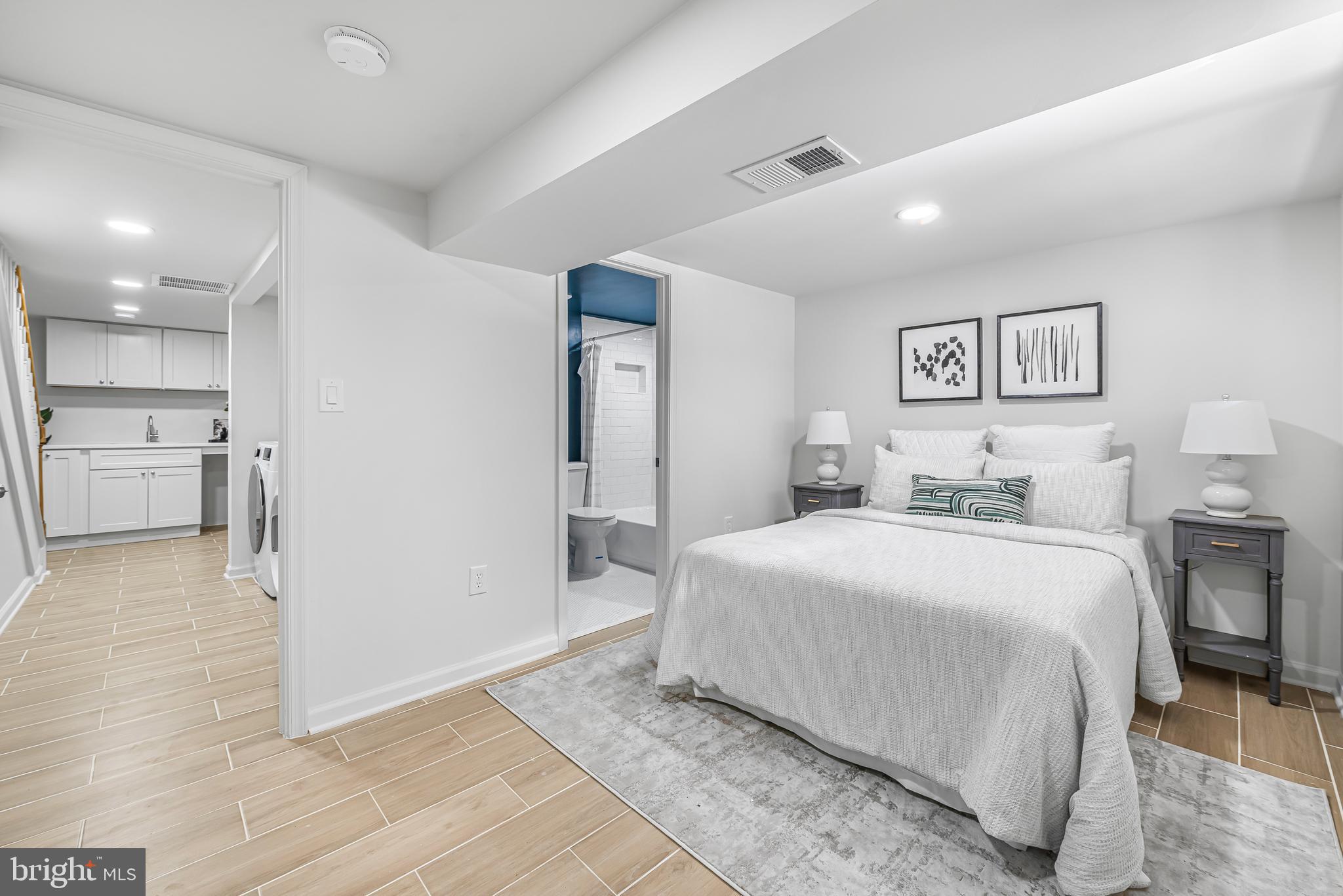 177 V Street Northeast Washington, DC 20002 - Photo 31 of 32 a spacious bedroom with a bed and a view of kitchen