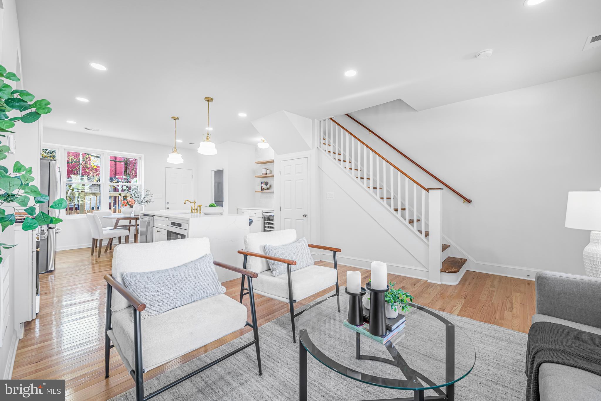 177 V Street Northeast Washington, DC 20002 - Photo 5 of 32 a living room with furniture and a dining table with kitchen view