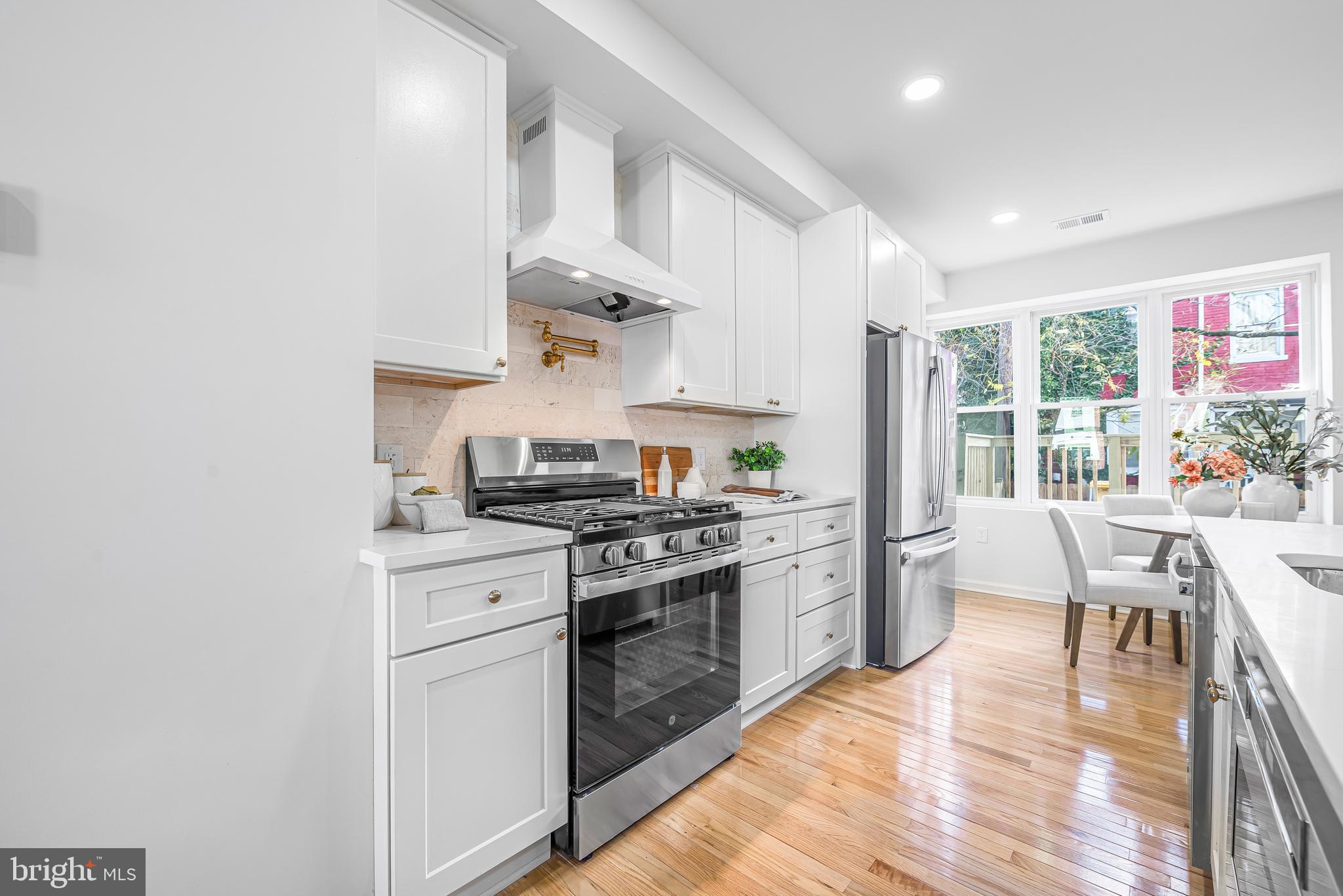 177 V Street Northeast Washington, DC 20002 - Photo 8 of 32 a kitchen with a stove a sink and a refrigerator