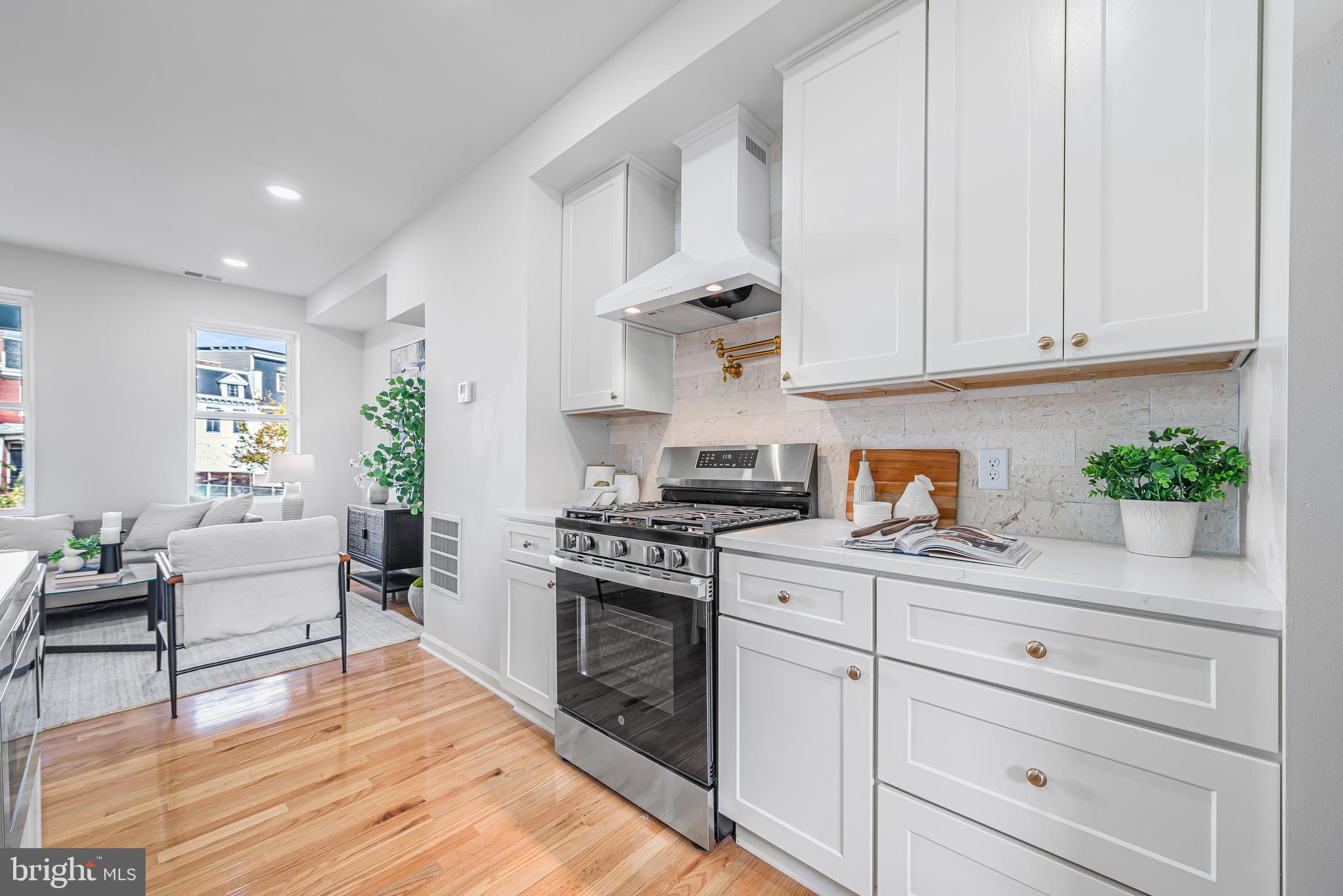 177 V Street Northeast Washington, DC 20002 - Photo 10 of 32 a kitchen with white cabinets and white appliances