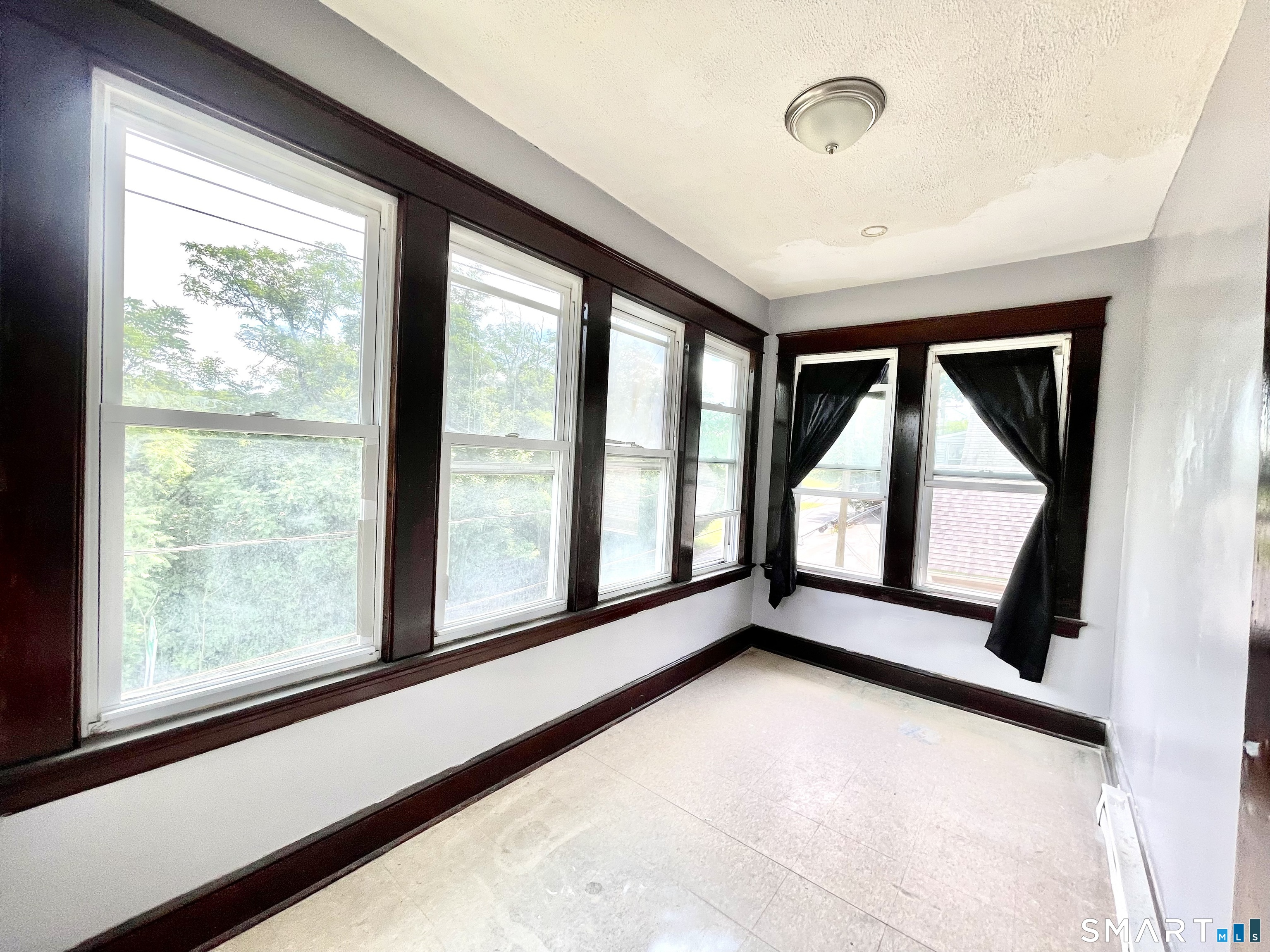 146 Charles Street, Unit 3 Waterbury, CT 06708 - Photo 16 of 20 a view of an empty room with a large window