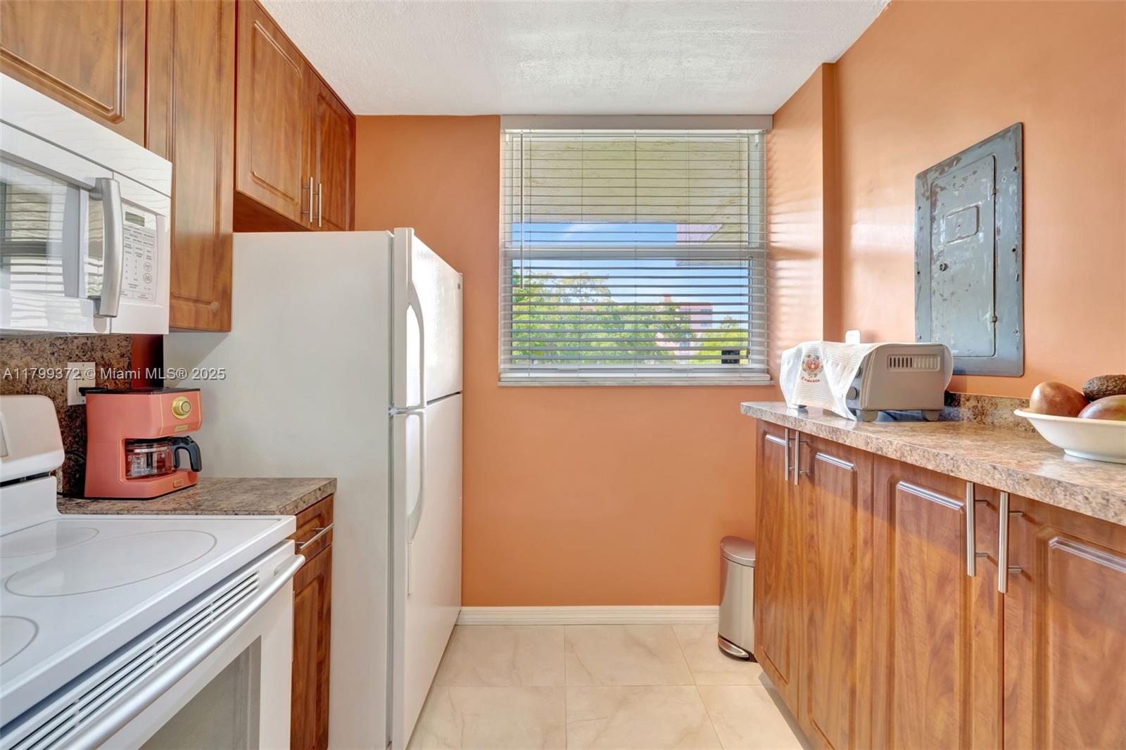 7080 Environ Boulevard, Unit 223 Lauderhill, FL 33319 - Photo 11 of 36 a kitchen with stainless steel appliances granite countertop a refrigerator and a sink