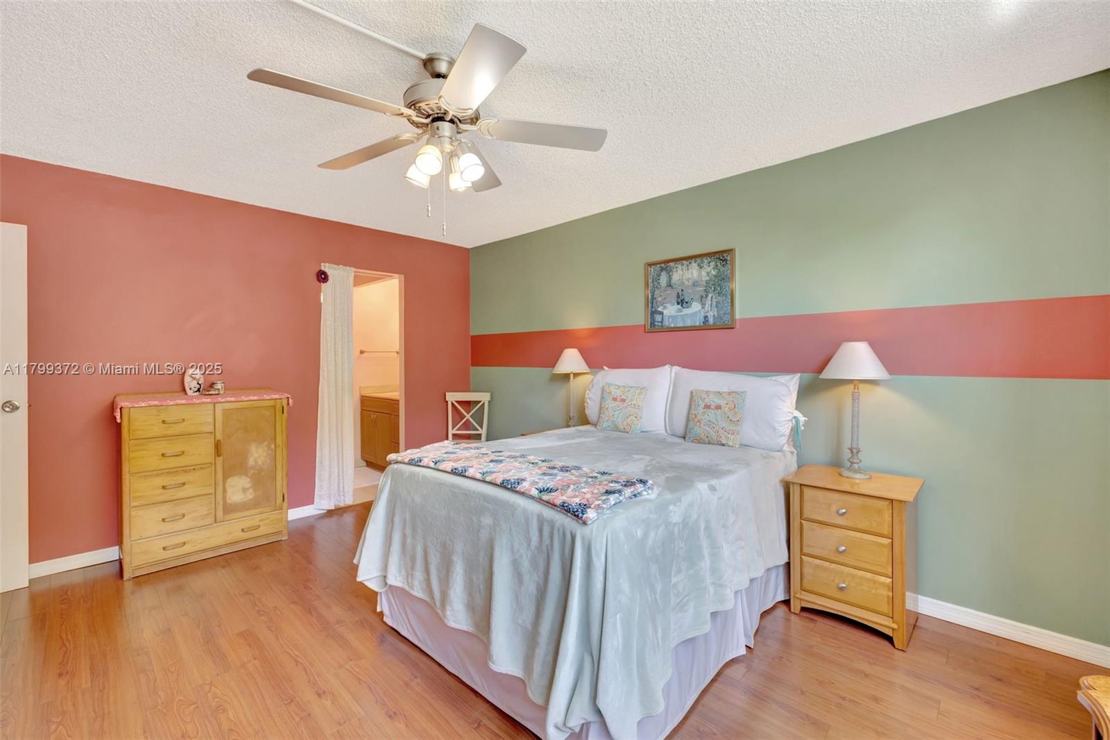 7080 Environ Boulevard, Unit 223 Lauderhill, FL 33319 - Photo 13 of 36 a bedroom with a bed and a chandelier