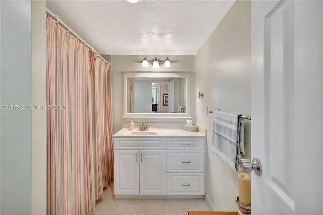 a bathroom with a double vanity sink mirror and