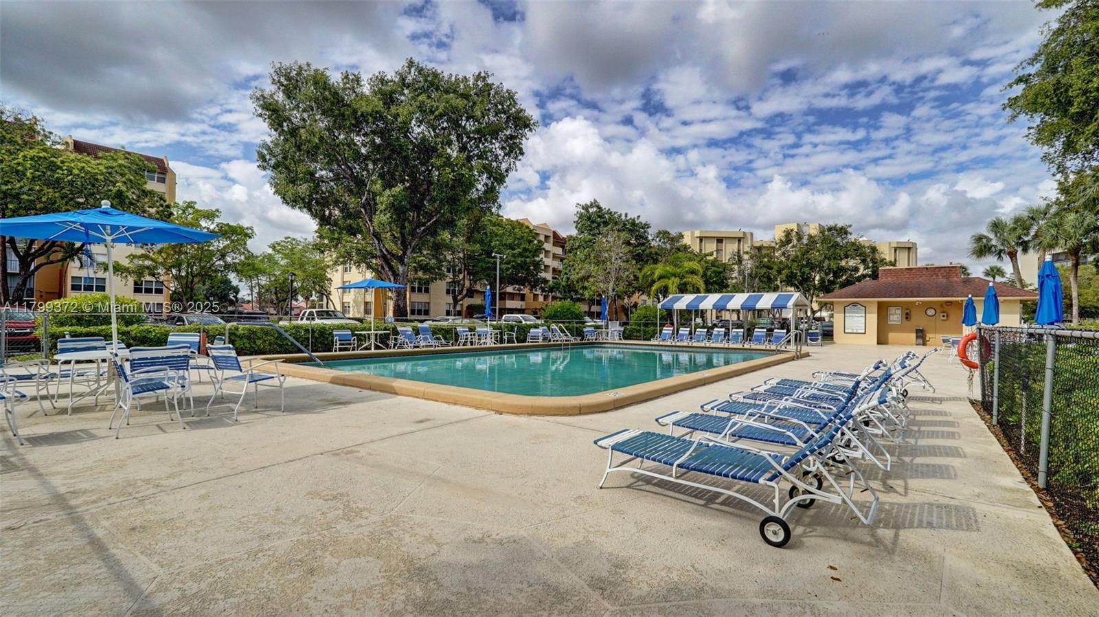7080 Environ Boulevard, Unit 223 Lauderhill, FL 33319 - Photo 31 of 36 an outdoor space with swimming pool and furniture
