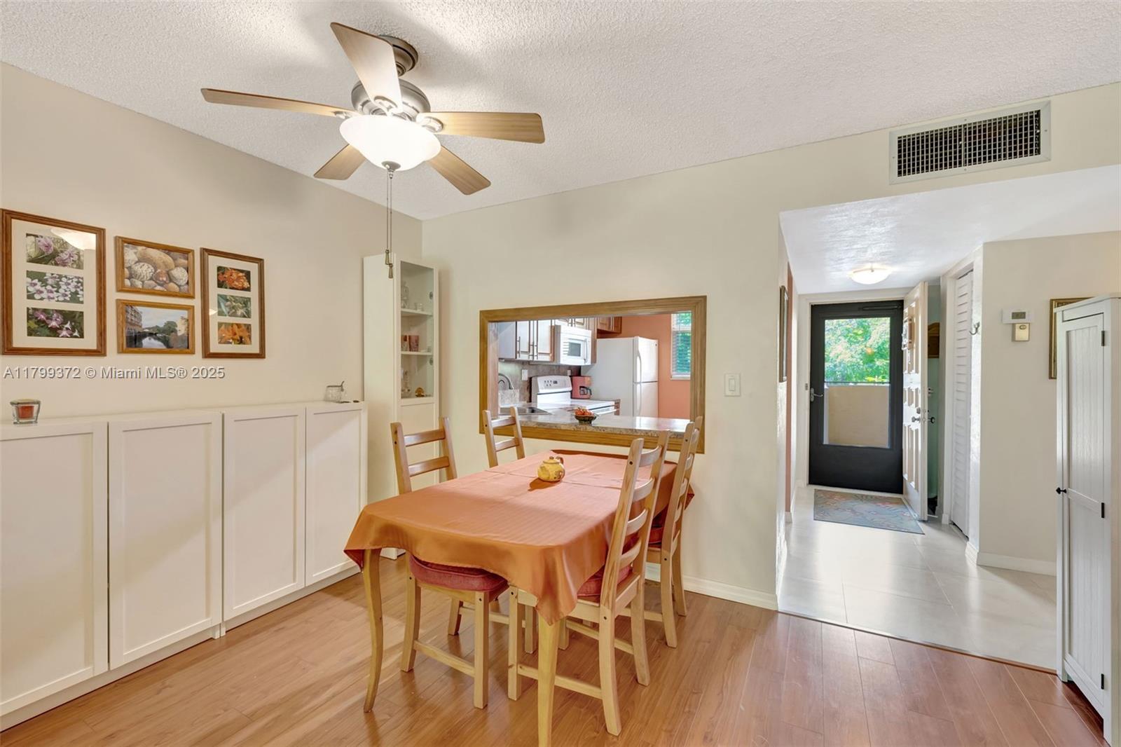 7080 Environ Boulevard, Unit 223 Lauderhill, FL 33319 - Photo 4 of 36 a view of a dining room with furniture window and wooden floor