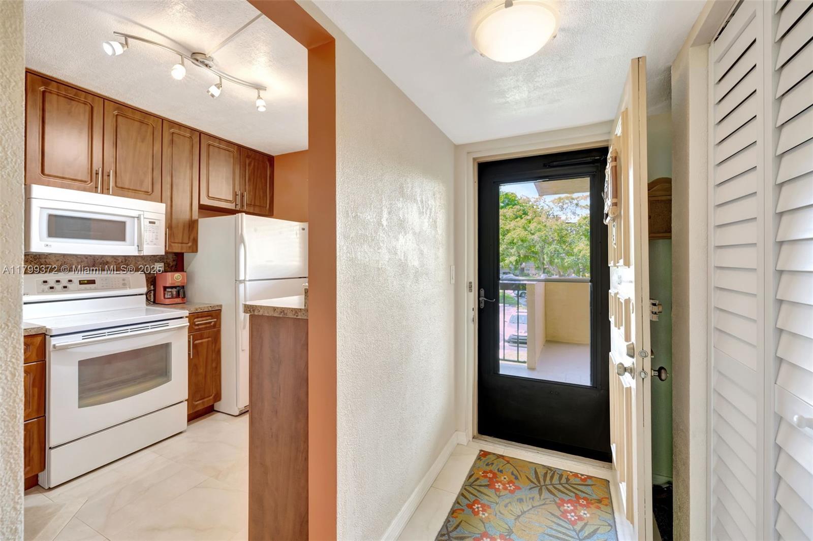 7080 Environ Boulevard, Unit 223 Lauderhill, FL 33319 - Photo 8 of 36 a kitchen with appliances cabinets and a sink