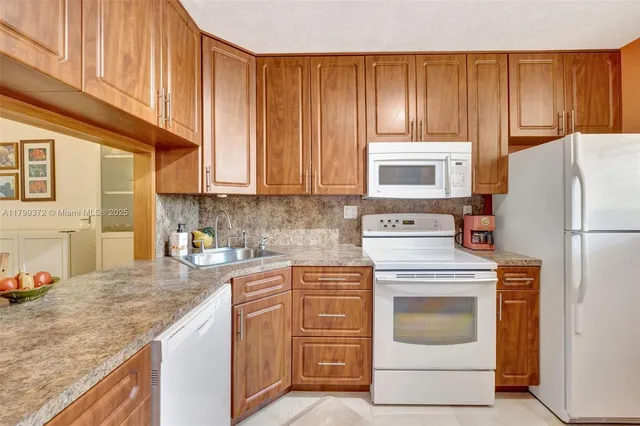 a kitchen with a stove top oven sink and cabinets