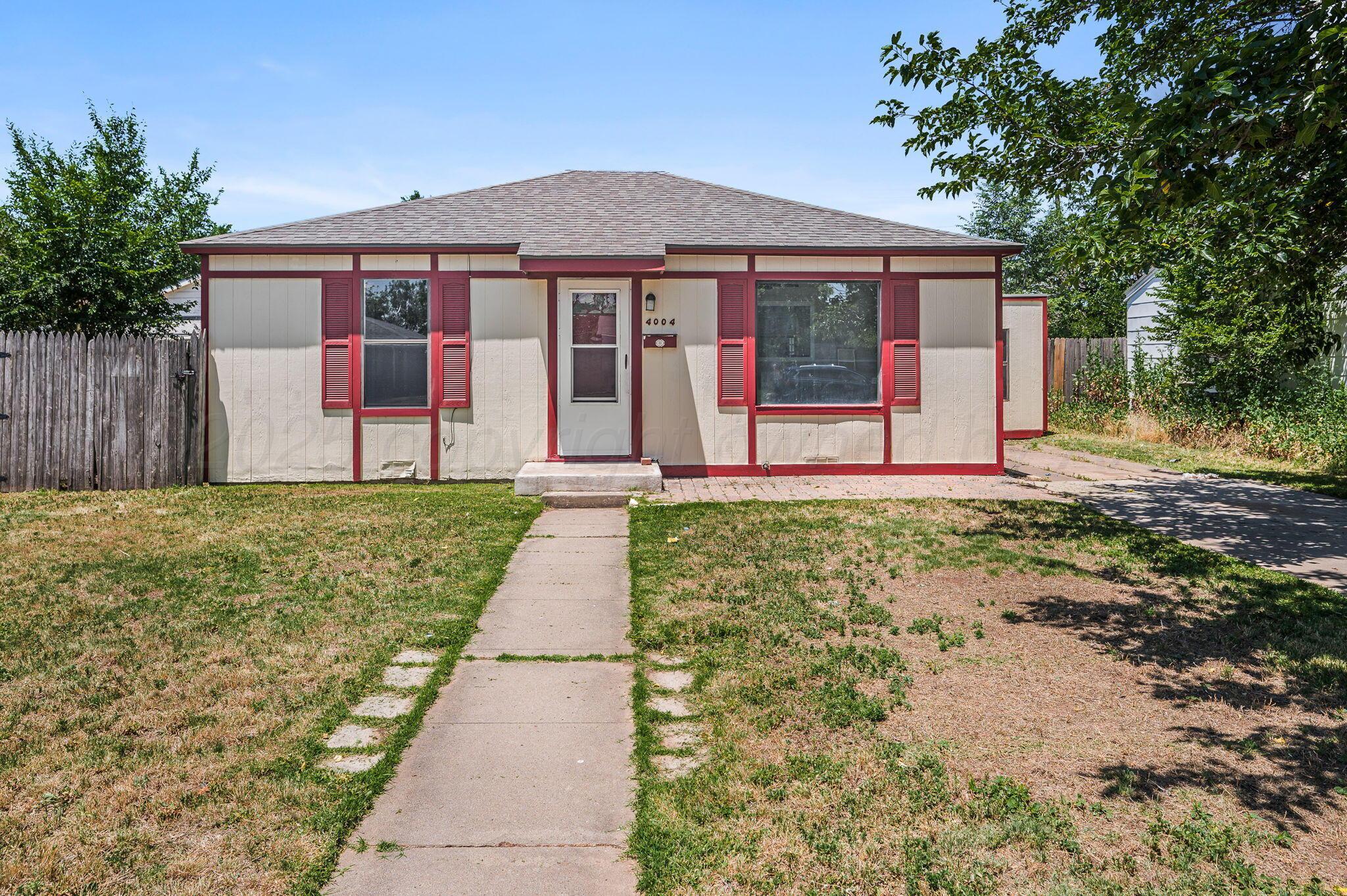 4004 South Van Buren Street Amarillo, TX 79110 - Photo 1 of 17 a front view of a house with a yard