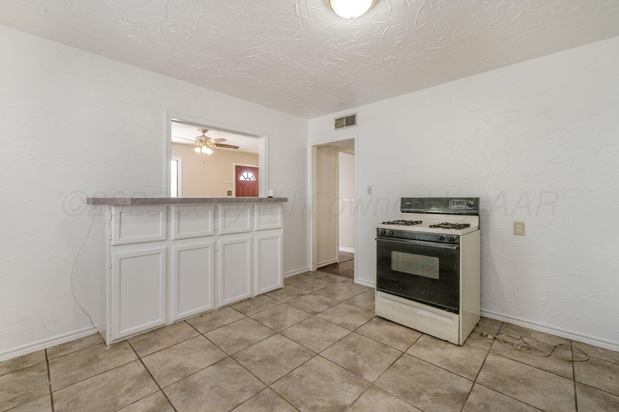 4004 South Van Buren Street Amarillo, TX 79110 - Photo 5 of 17 a kitchen with cabinets and oven