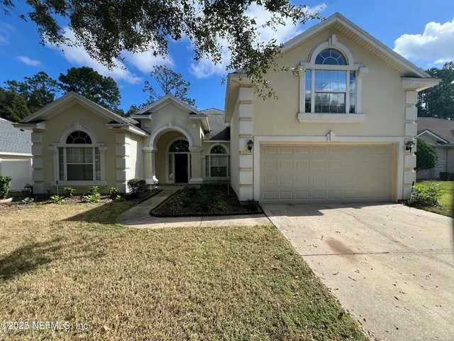 a front view of a house with a yard