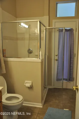 a bathroom with a toilet and a shower
