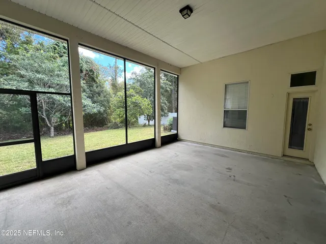 a view of an empty room with windows