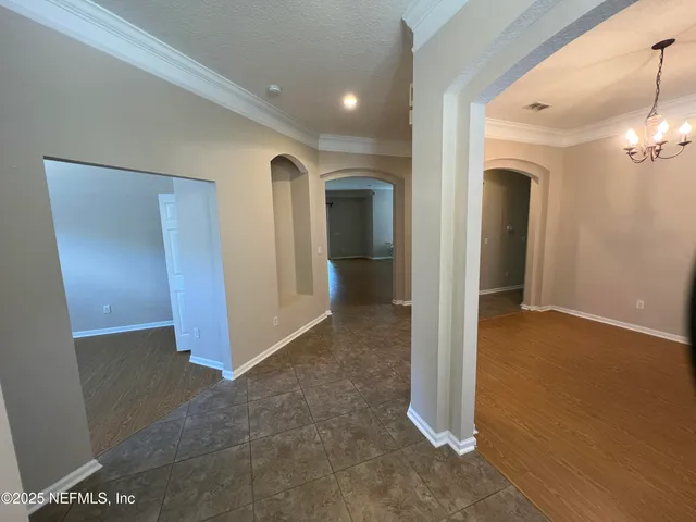 a view of a hallway with wooden shelves