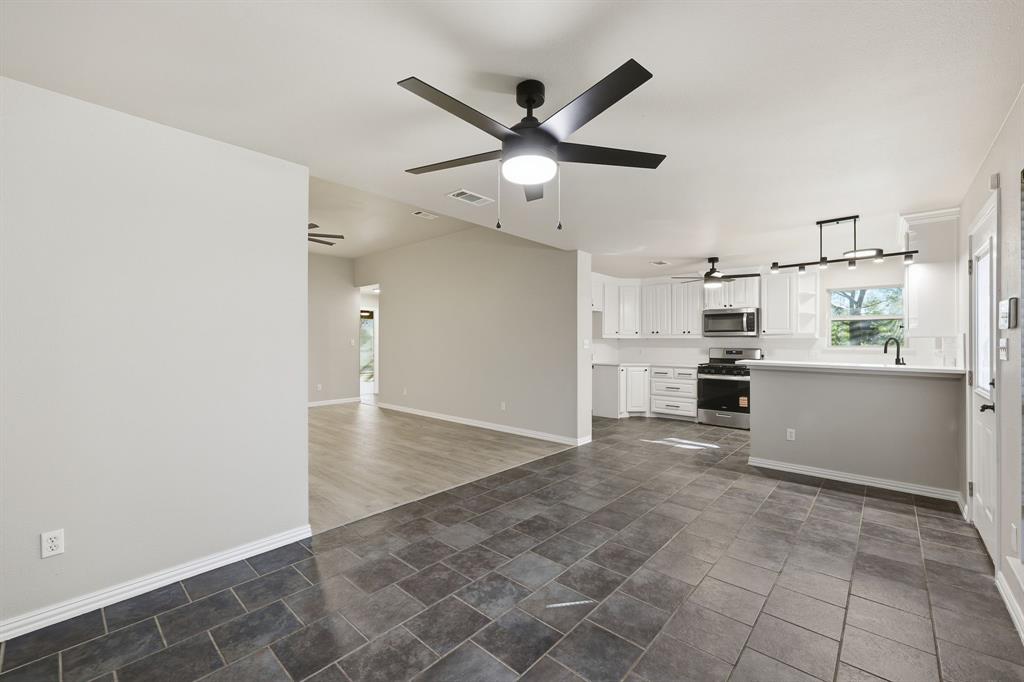 8875 Fm 2450 Sanger, TX 76266 - Photo 13 of 28 a view of a kitchen with a sink and dishwasher refrigerator stove