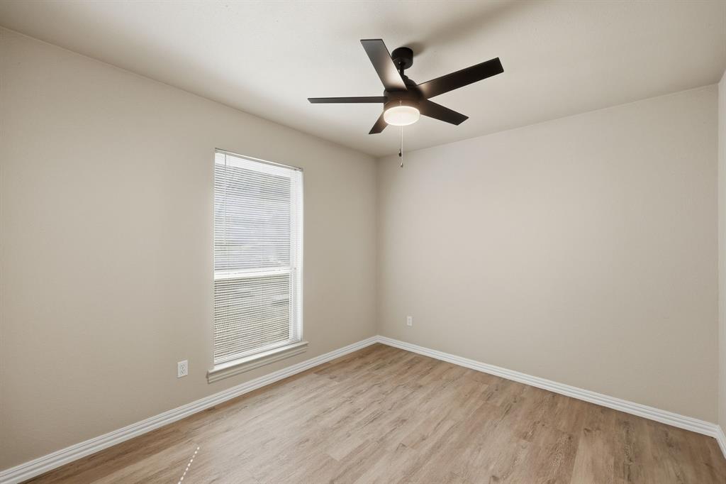 8875 Fm 2450 Sanger, TX 76266 - Photo 17 of 28 an empty room with a window and a fan